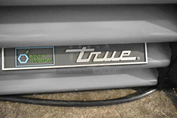 True GDM-12-HC cooler logo with natural refrigerant label, highlighting energy efficiency.