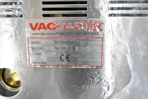 Vacmaster VP215 stainless steel vacuum sealer label showing model, voltage, factory date, and production code details.