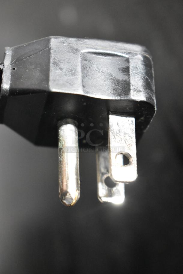 Close-up of a black electrical plug for the Electrolux FRT21IL6JW2 cooler, 115 volts, 1 phase.