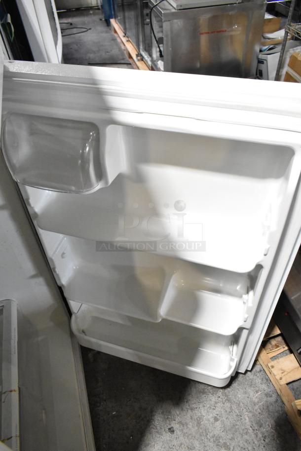 Electrolux FRT21IL6JW2 reach-in cooler with freezer, 115 volts, 1 phase. White interior, shelves visible, good condition.