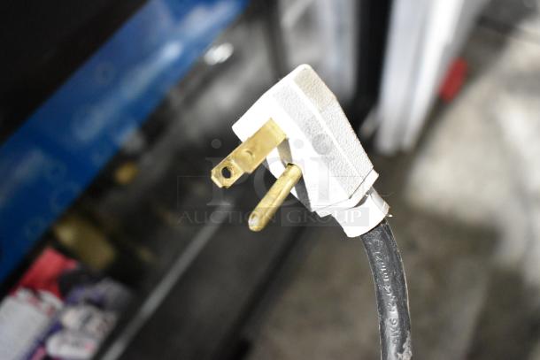 Close-up of the power plug on a 2017 True GDM-41SL-48-HC-LD commercial cooler, showing a standard three-prong plug on a black cord, suitable for 115 volts, 1 phase.
