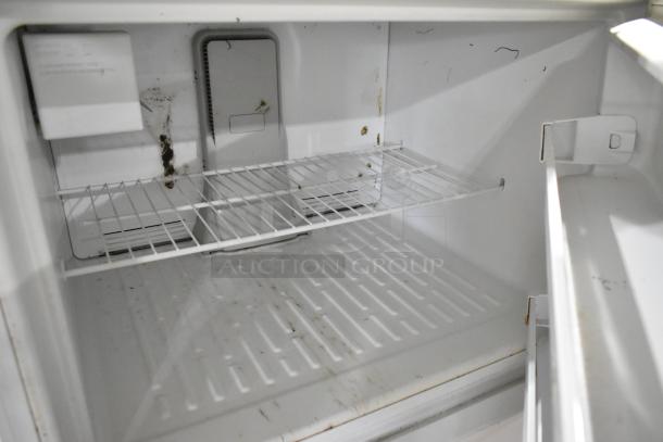 Maytag M1TXEGMYW01 reach-in cooler with freezer, 115 volts, 1 phase, interior shows signs of wear and rust.