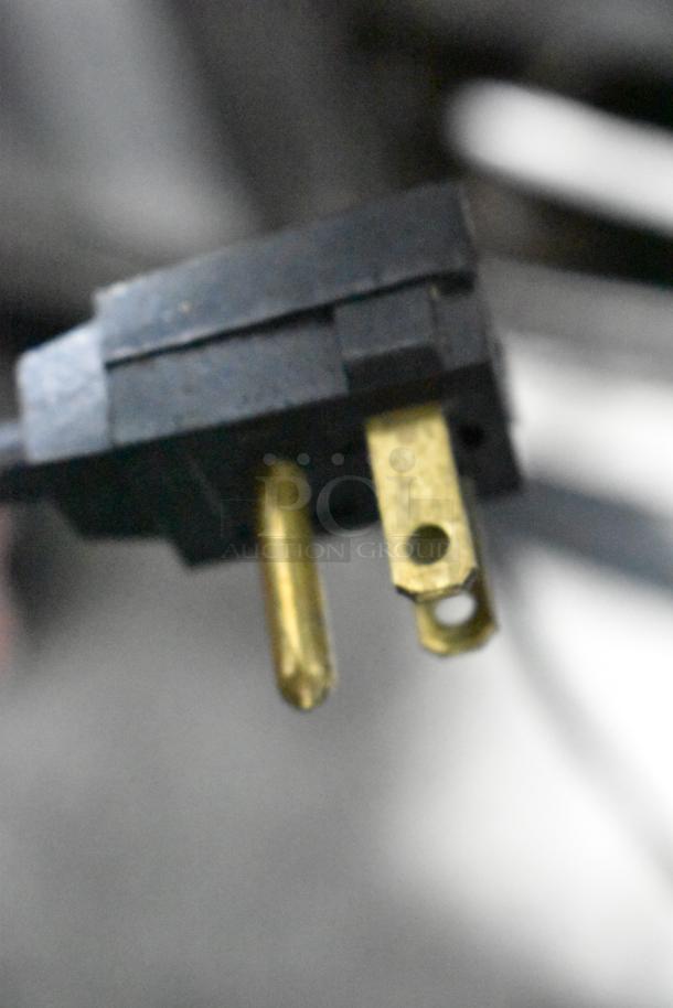 Zoomed-in view of a power plug for Maytag M1TXEGMYW01 cooler with freezer, showing prongs for 115 Volts, 1 Phase connection.