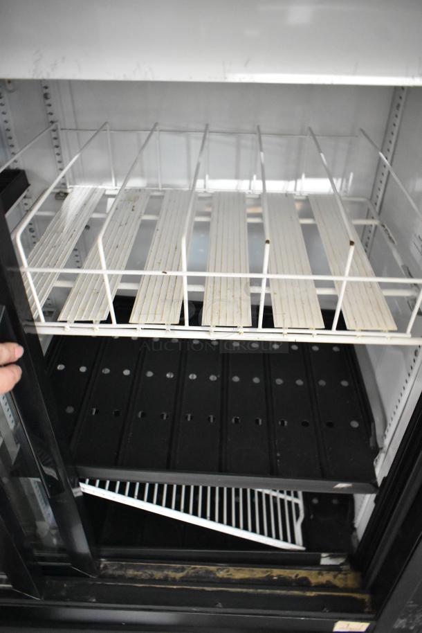 2017 True GDM-41SL-48-HC-LD commercial cooler, metal, 2 doors, with poly coated racks, 115 volts, 1 phase, interior view.