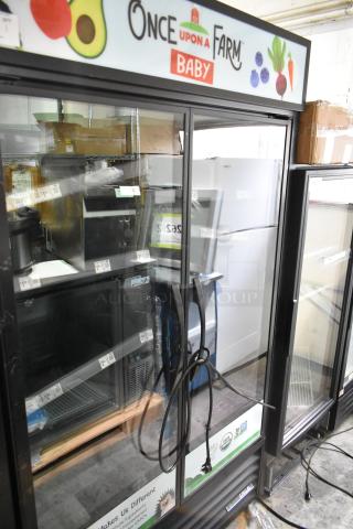 True TVM-48SL-HC 2 Door Reach-In Cooler Merchandiser, metal racks, 115V, 1 Phase, branded "Once Upon a Farm", good condition.