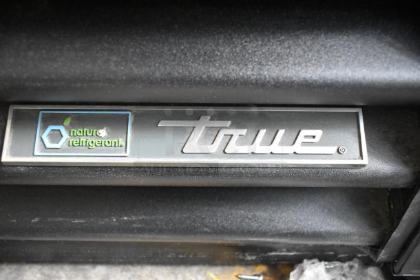 Label displaying "True" brand and "natural refrigerant" logo on a black surface, part of the TVM-48SL-HC cooler.