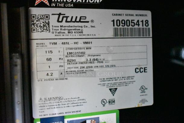 2024 True TVM-48SL-HC cooler label showing model info, 115V, 1 phase, R290 refrigerant, and compressor details.