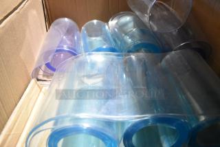 Box of rolled clear plastic strip curtains in a cardboard box, showcasing transparency and smooth surface for easy installation.