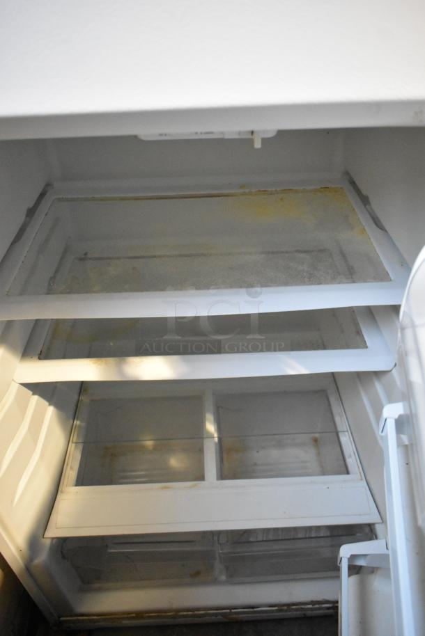 2022 Whirlpool WRT314TFDW03 cooler and freezer interior with multiple shelves, visible wear, 115 volts, 1 phase.