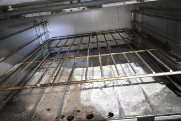 Garland stainless steel commercial oven interior with grates. Used condition, ideal for professional kitchens.
