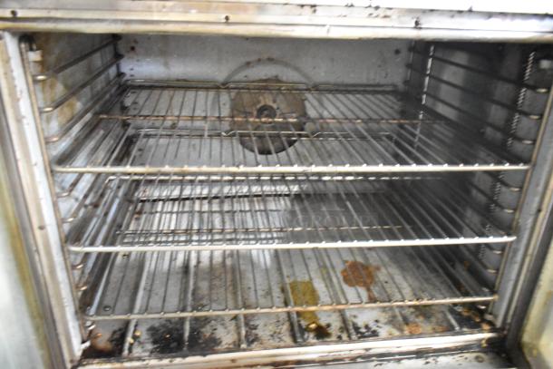 Blodgett EF-111 convection oven interior with metal racks, stainless steel, 480V, 3-phase. Some visible wear and residue.
