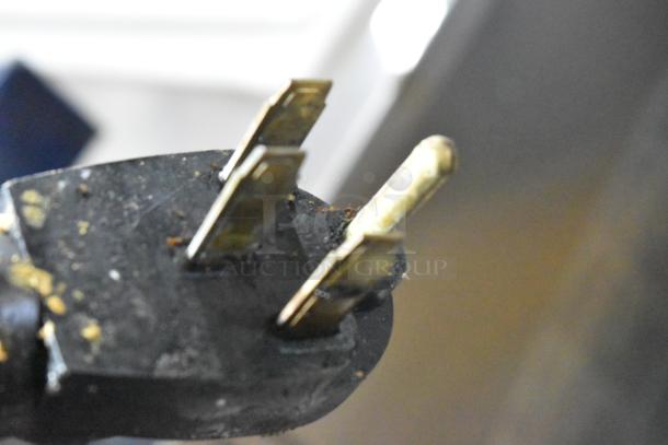 Electric plug of Garland Stainless Steel Commercial Flat Top Griddle, close-up view, showing wear.