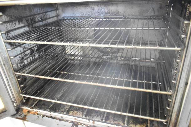 Blodgett EF-111 stainless steel convection oven interior with metal racks, visible wear, 440V, 3 phase. View-through doors.