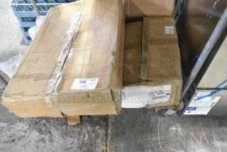 12 new scratch and dent items in boxes, including Bakers Lane baking pans, stainless steel bin lids. Boxes show shipping labels.