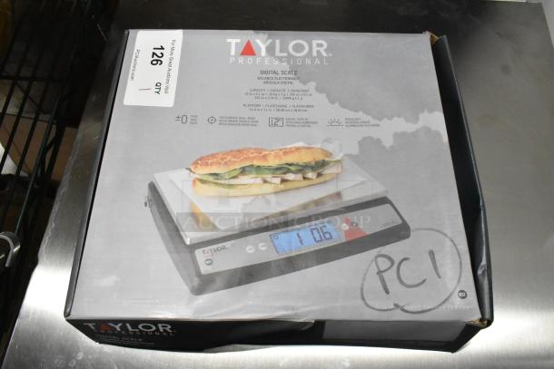 Brand new Taylor TE22OS 22 lb. digital portion control scale, oversized platform, slight box damage, model info visible.