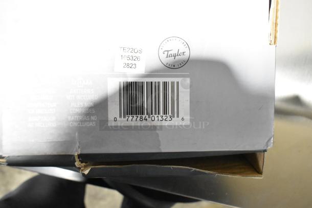 Brand new Taylor TE22OS digital scale box showing barcode, model number, and minor box damage.