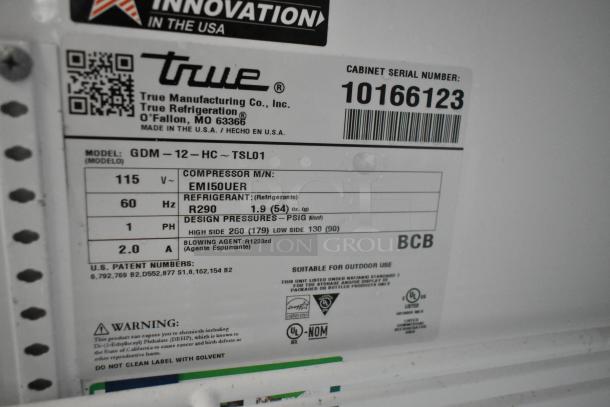 Label on 2021 True GDM-12-HC commercial cooler showing model, voltage, refrigerant type, and patent details.