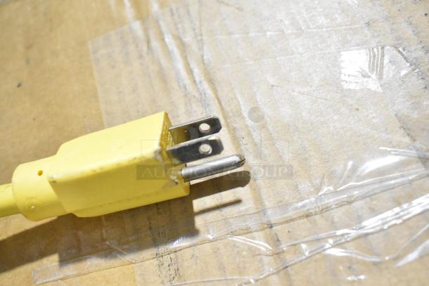 A yellow power plug from the Lavex 978LAVP20A floor cleaning machine, 115 volts, single-phase.