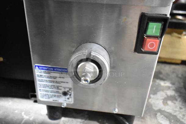 2025 Pro-Cut KG-12-SS stainless steel electric meat grinder, scratch and dent, model label and control switches visible.