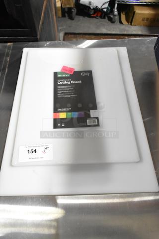 Two brand new 40720155WH Choice 20" x 15" x 1/2" white polyethylene cutting boards, labeled "scratch and dent", with auction tags.