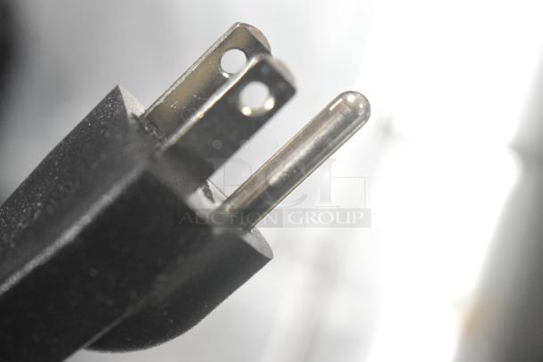 Close-up view of a power plug for the Cuisinart Stay Countertop 4 Slot Toaster, brand new with minor scratches.