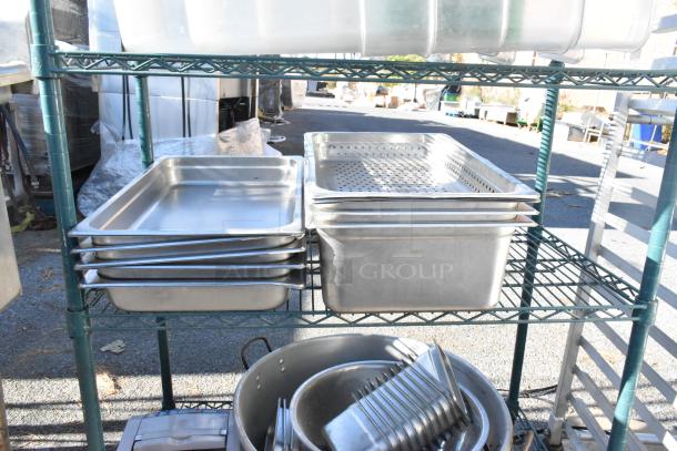Green 4-tier shelving unit with poly bins and metal baking pans; buyer must dismantle.