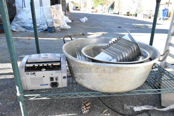Green finish 4-tier shelving unit with poly bins, metal baking pans, and an electrical device on the shelf. Buyer must dismantle.