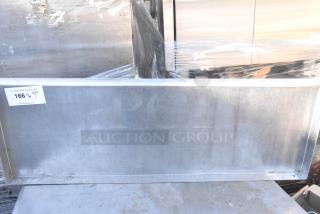 Metal wall mount shelf in used condition, displaying a reflective surface and sturdy construction. Auction label indicating lot 166.