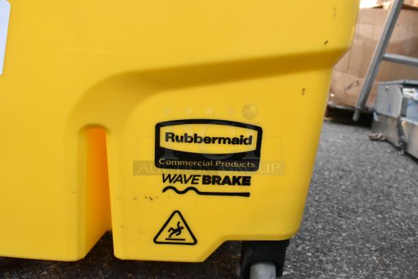 Rubbermaid yellow poly mop bucket with wringing attachment, WaveBrake logo, and caution symbol. Durable and commercial-grade.