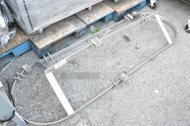 Metal Pot Rack with S Hooks on ground; oval shape, used condition, includes multiple S hooks for hanging.