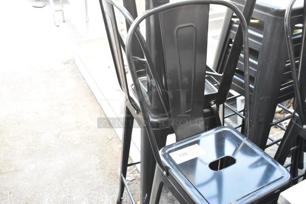 5 black metal Tolix style bar stools, stackable, with perforated seats. Label reads "176." Good condition.