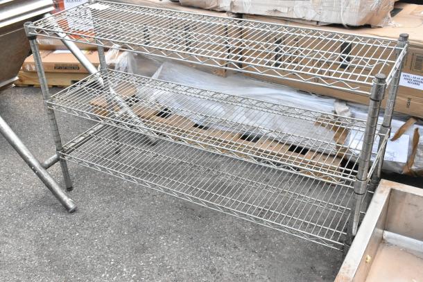 Chrome finish 3-tier wire shelving unit, in good condition, features adjustable shelves, ideal for storage solutions.