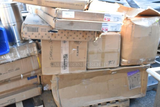 Nine brand new scratch and dent boxes, various sizes, visible labels including "DAMAGED," stacked on a pallet.