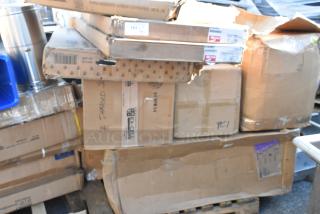 Nine brand new scratch and dent boxes, various sizes, visible labels including "DAMAGED," stacked on a pallet.