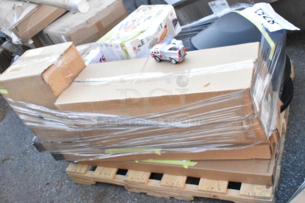 14 new scratch and dent items including a fan, door strips, and vegetable slicer, wrapped on a pallet.
