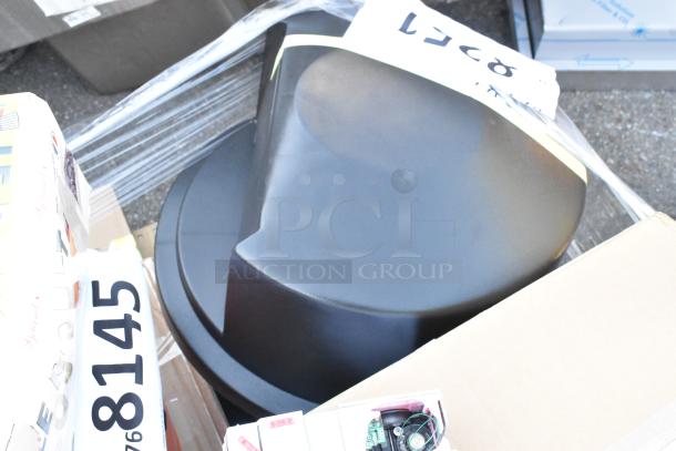 Scratch and dent auction items including a black fan, sealed boxes, and packaging. Items are new but may have minor flaws.