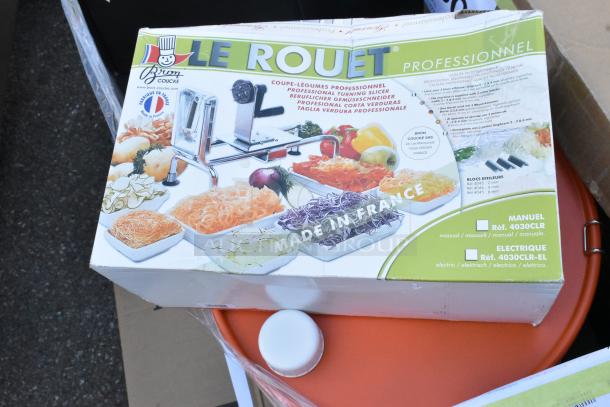 Box of Le Rouet Professional Vegetable Slicer by Bron Coucke, brand new, showing various cut vegetables, "Made in France."