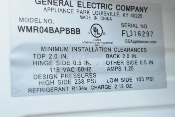 Label on GE mini cooler model WMR04BAPBBB, 115V, 1 phase. Features installation clearances, UL listed, refrigerant R134a.