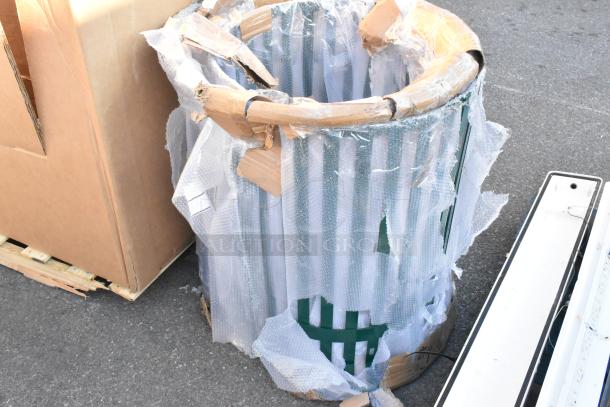 Brand new green slat trash can shell, visible scratch and dent marks, partially wrapped in protective packaging.
