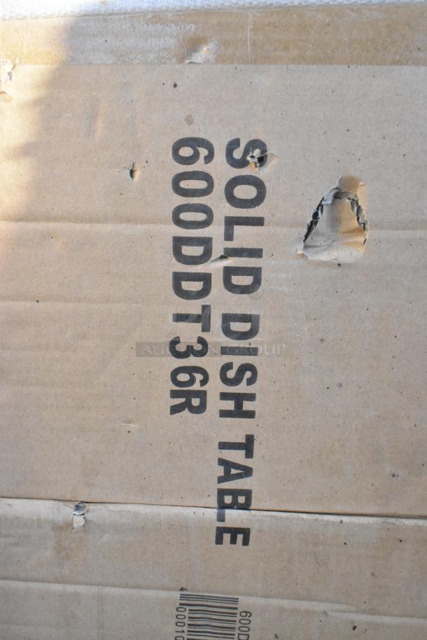 Cardboard box with text "Solid Dish Table 600DDT36R" and visible dents. Auction is for 10 new scratch-and-dent items.