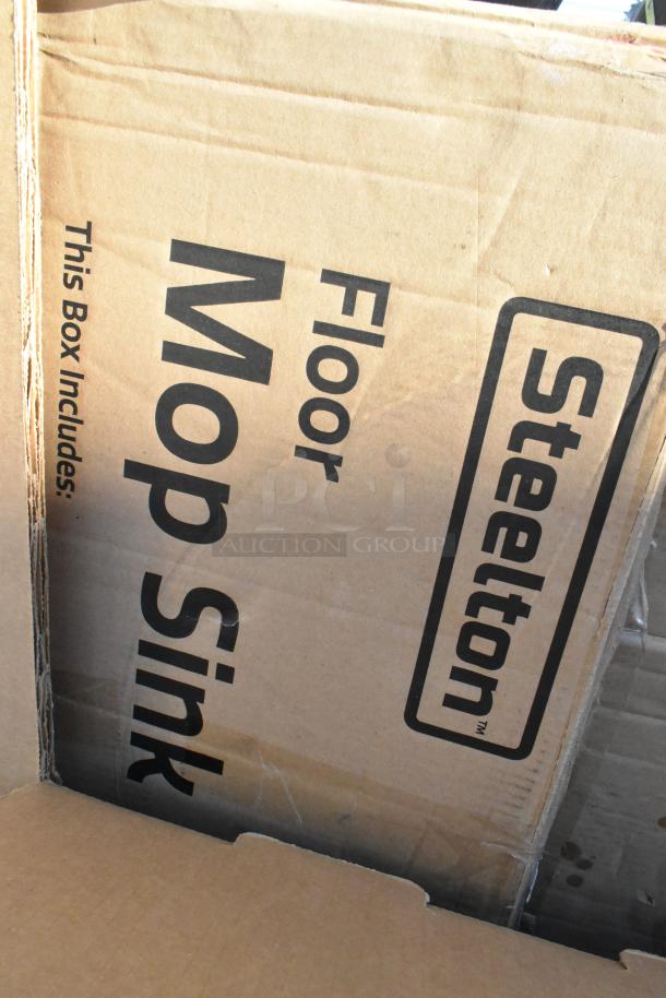 Cardboard box labeled "Steelton Floor Mop Sink" indicating one of 10 brand new scratch and dent items for auction.