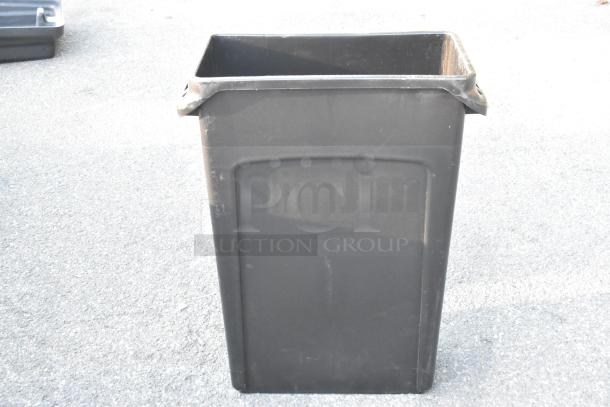 Rubbermaid Black Poly Slim Jim Trash Can, rectangular, durable plastic, slight wear visible. Perfect for narrow spaces.