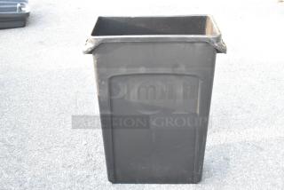 Rubbermaid Black Poly Slim Jim Trash Can, rectangular, durable plastic, slight wear visible. Perfect for narrow spaces.