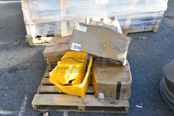 7 new scratch and dent items on a pallet, including a yellow ingredient bin, boxes labeled with barcodes, and a table.