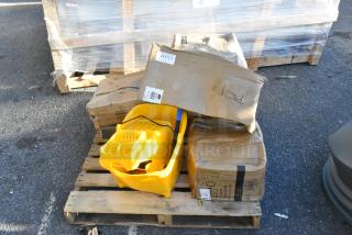 7 new scratch and dent items on a pallet, including a yellow ingredient bin, boxes labeled with barcodes, and a table.