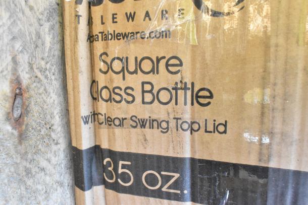 Cardboard box labeled "Square Glass Bottle with Clear Swing Top Lid, 35 oz." from Apa Tableware.