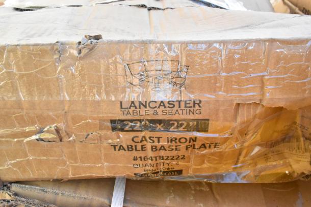 Cardboard box labeled "Lancaster Table & Seating," 22"x22" cast iron table base plate, 4 units, showing damage.