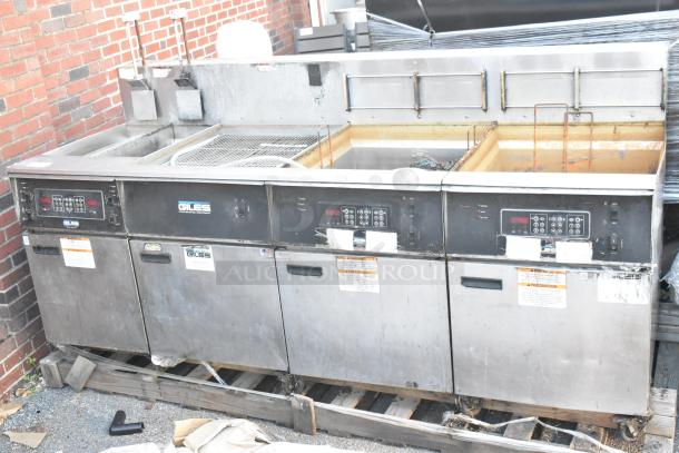 Giles EOF-24 stainless steel 3-bay electric fryer with dumping station on casters, 480 volts, commercial use, visible control panels and warning labels.
