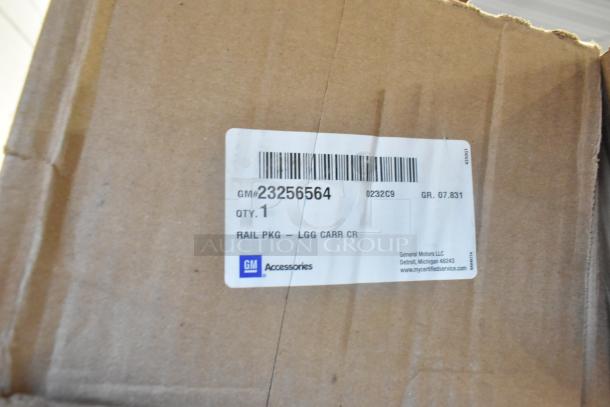 Box with GM label for item 23256564, includes "RAIL PKG - LGG CARR CR." Item is brand new from General Motors.