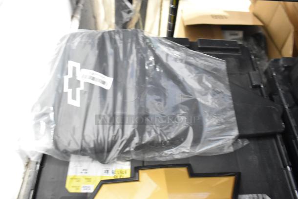 Brand new lot of various car parts, including black Chevy emblems, in a poly bin. Packaging intact and parts labeled.